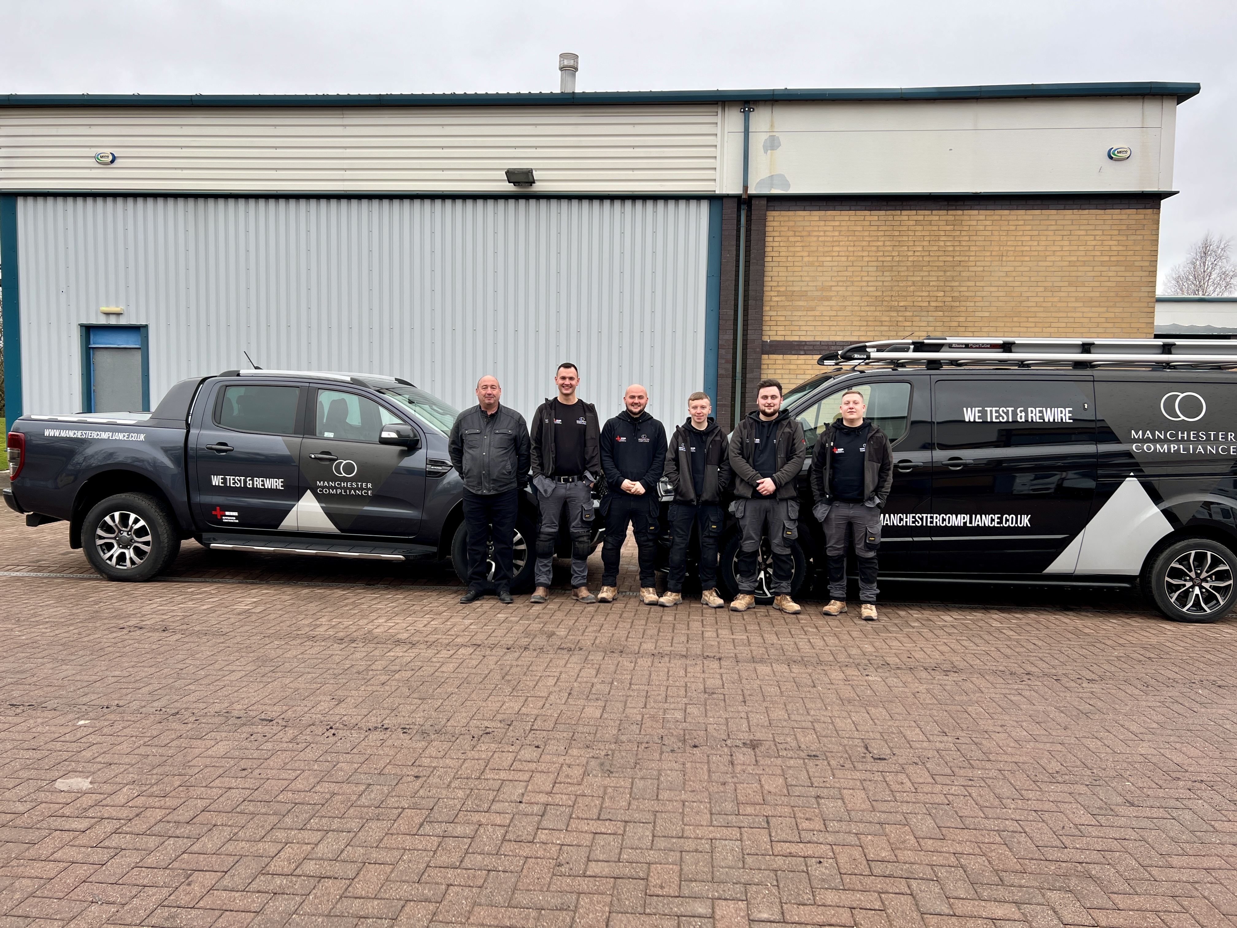 Manchester Compliance industrial electrical testing team with company vehicles