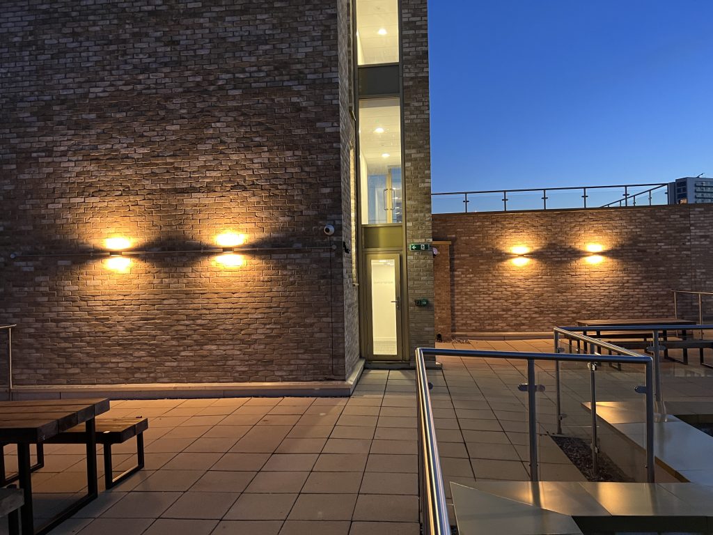Build to rent apartment terrace in Manchester at night